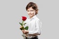 Boy holding a red rose flower for Valentines day
